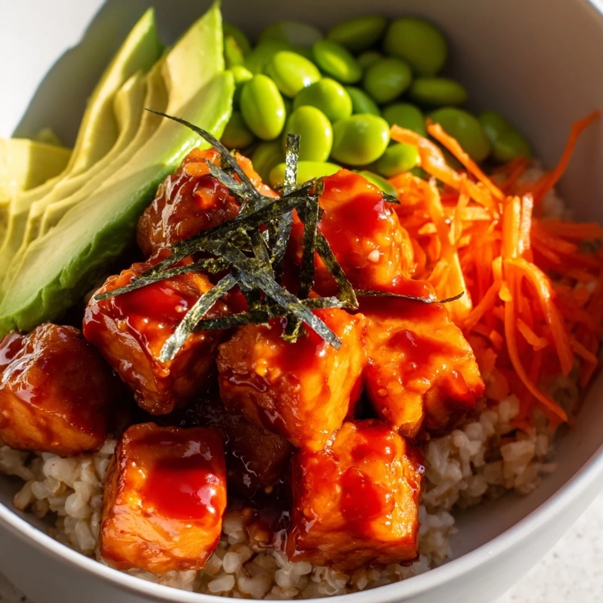 Close-up of a vibrant Spicy Tuna Poke Bowl with avocado, cucumber, and edamame.