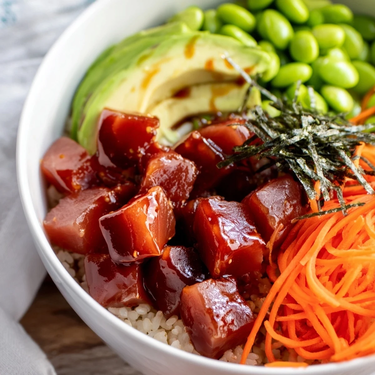A fresh, colorful Spicy Tuna Poke Bowl topped with creamy avocado and spicy mayo.