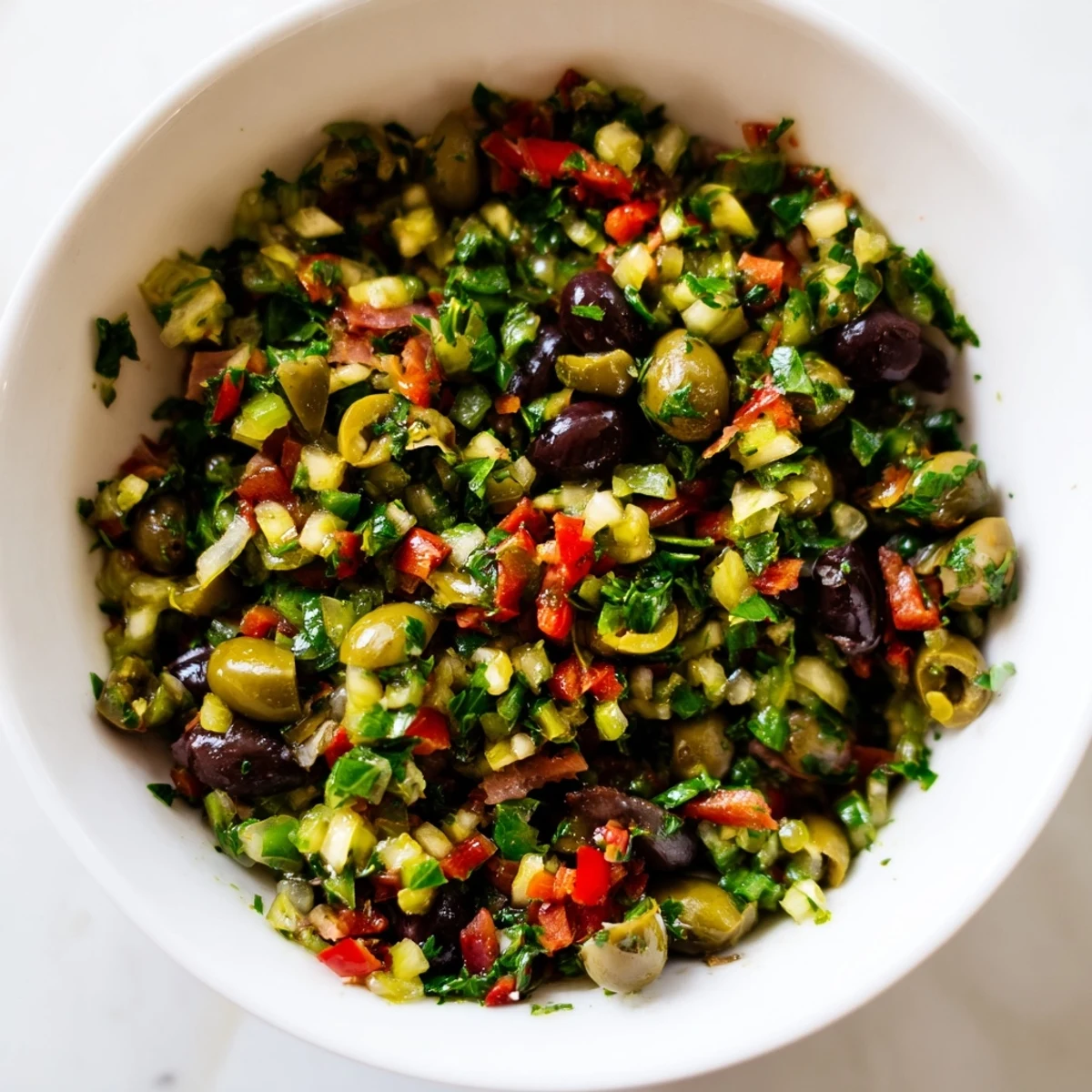 Tossed New Orleans Muffuletta Salad with halal deli meats, olives, and a bright vinaigrette.