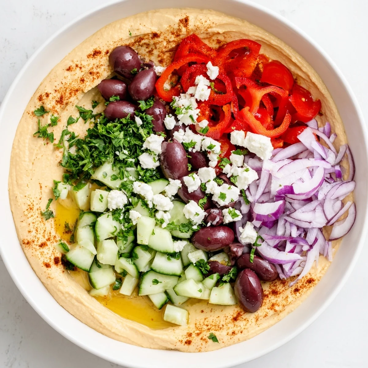 Fresh Mediterranean Hummus Bowl with warm pita wedges, crisp cucumbers, and vibrant olives.  