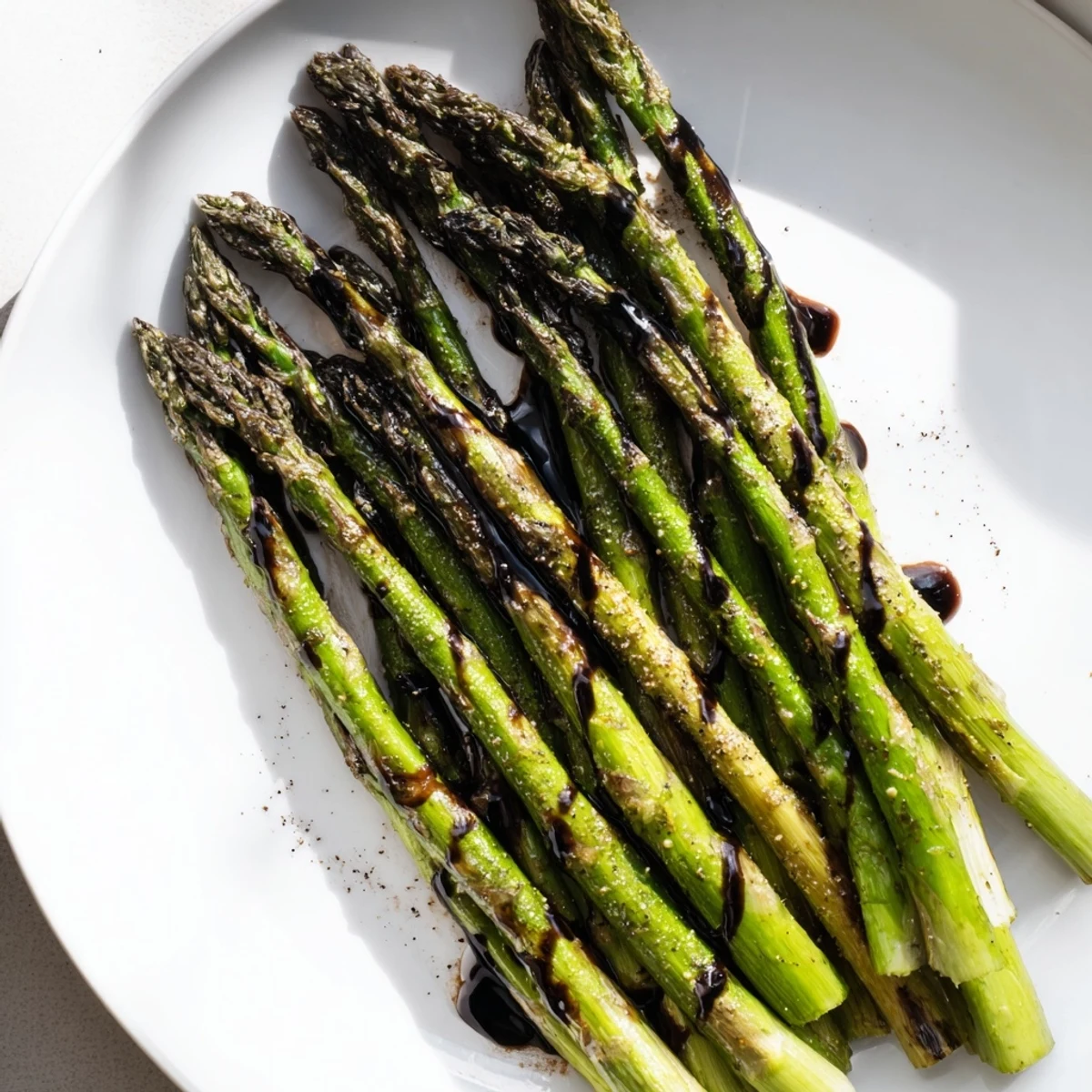 Elegant roasted asparagus with balsamic glaze served alongside grilled chicken for a nutritious dinner.