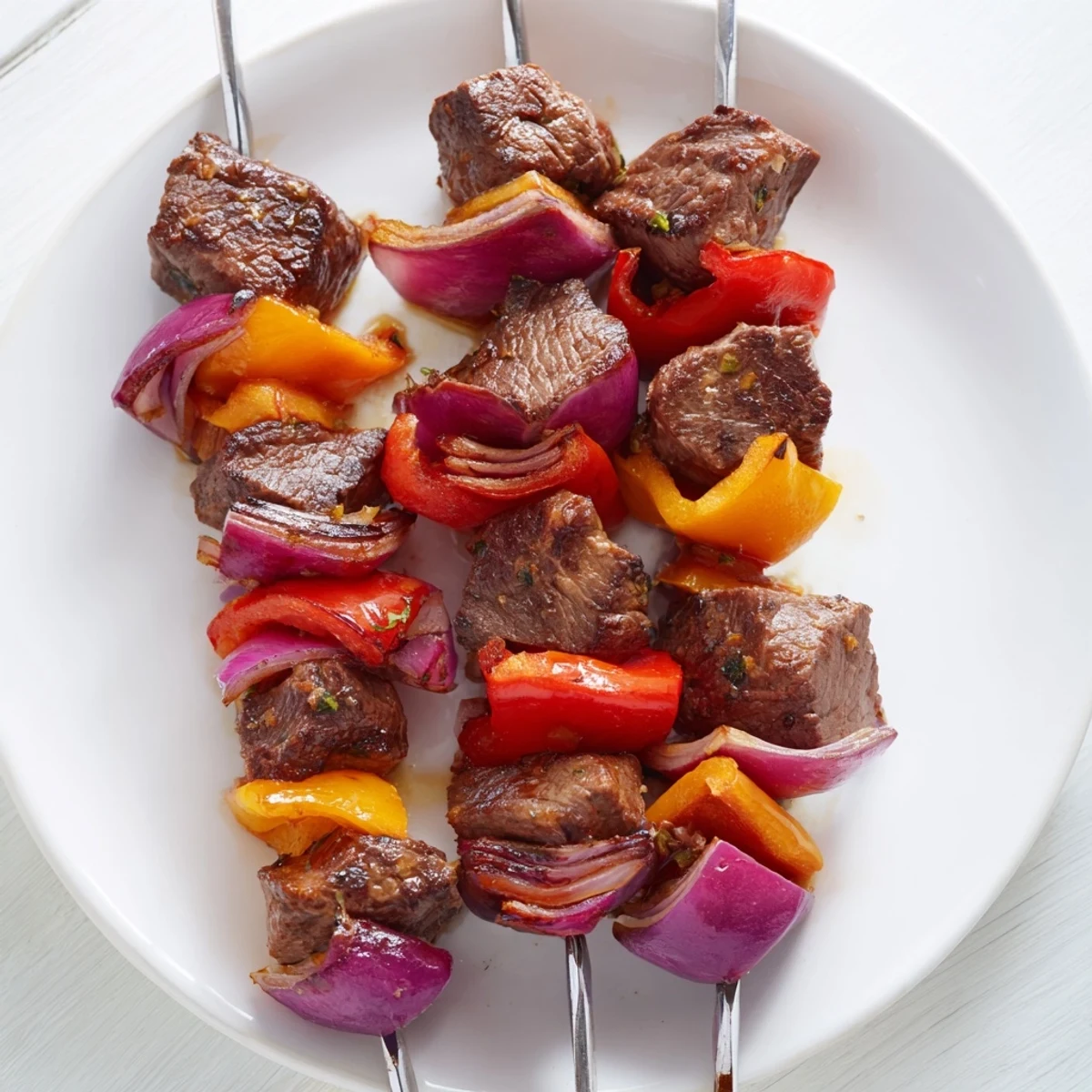 Sizzling Beef Kebabs with Bell Peppers and Onions fresh off the grill, with juicy charred edges and vibrant colors.