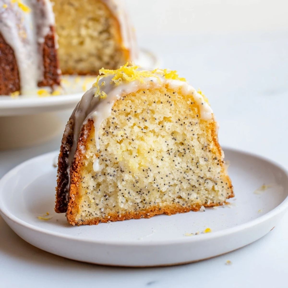 Freshly baked Lemon Poppy Seed Bundt Cake with Icing, served on a rustic wooden table with a knife ready to slice the tender dessert.