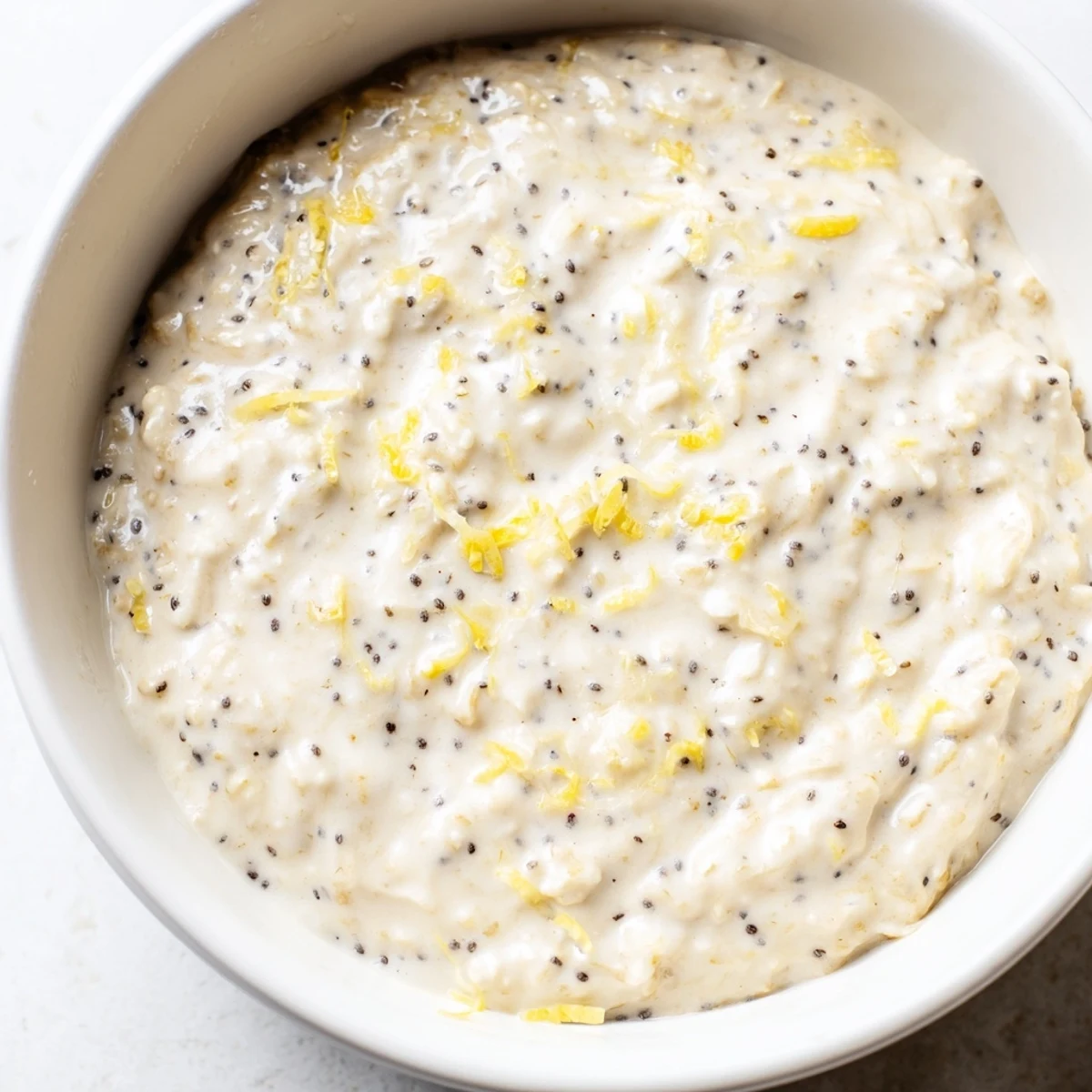 Overnight chilled Vegan Lemon Poppy Seed Overnight Oats in a bowl, ready for a healthy breakfast.