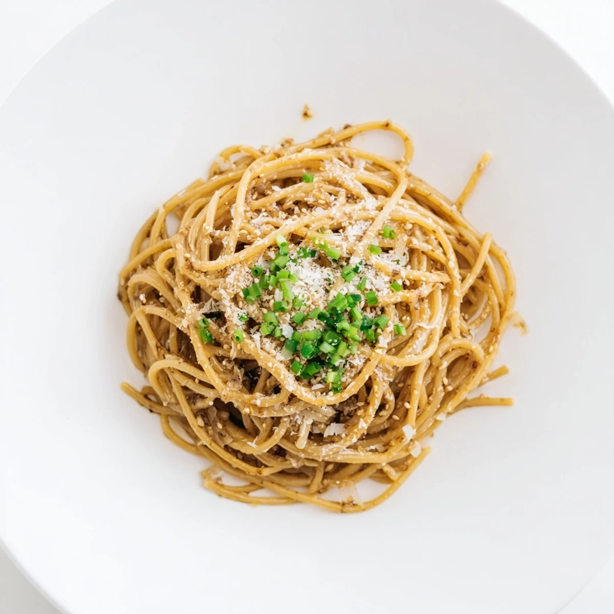 Fork twirling Garlic Noodles from a white bowl, steam rising from the rich garlicky sauce, showcasing al dente noodles and toasted sesame seeds for an easy Asian-inspired meal.