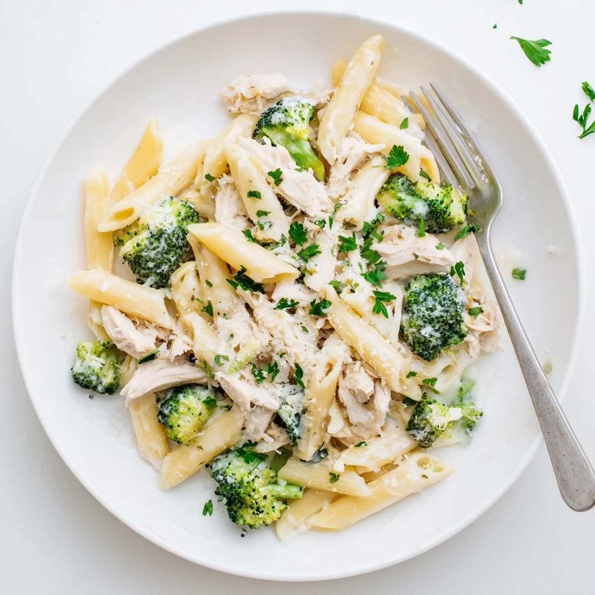 Creamy rotisserie chicken broccoli pasta tossed in garlic parmesan sauce and garnished with fresh parsley