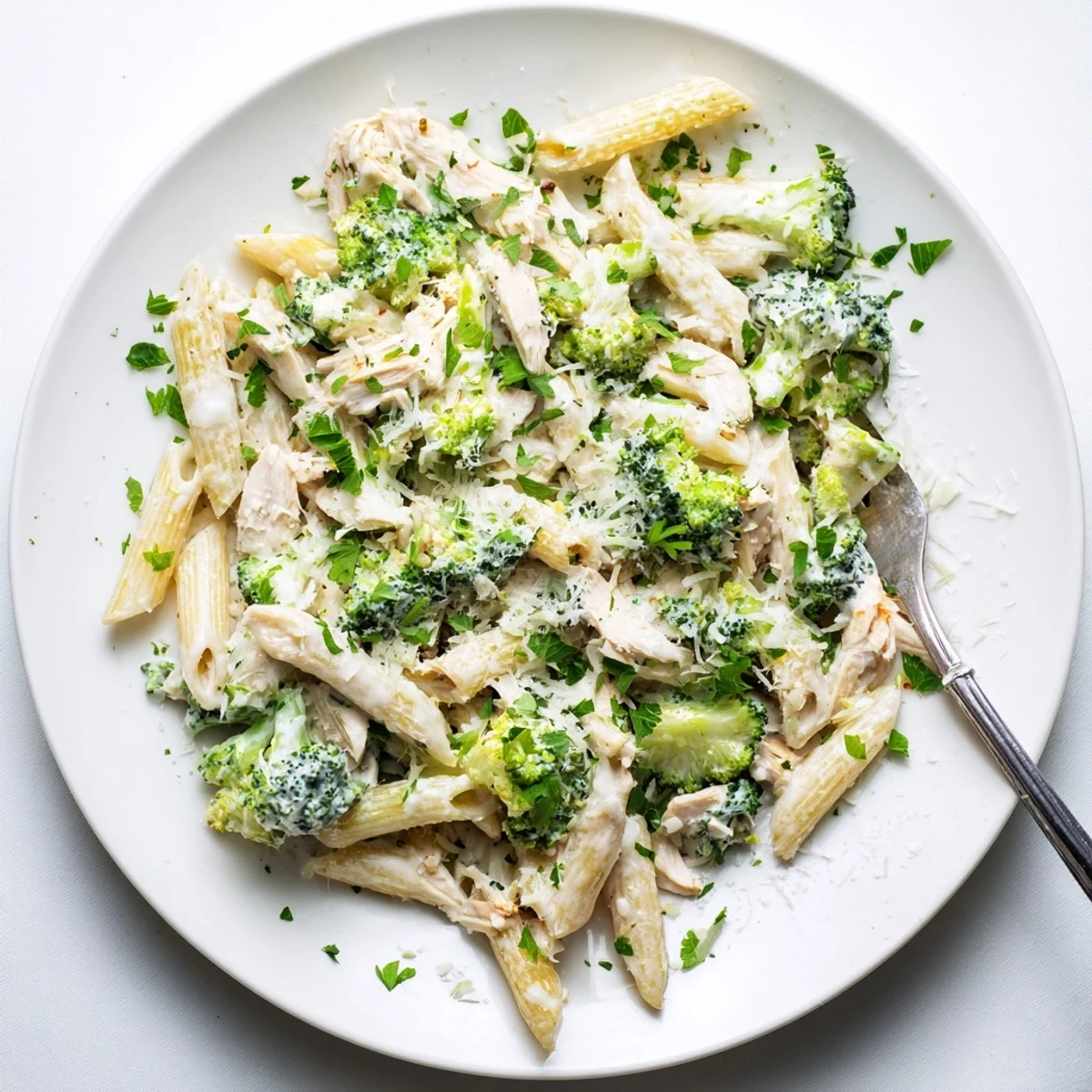 Easy weeknight dinner featuring rotisserie chicken broccoli pasta coated in smooth creamy garlic parmesan sauce