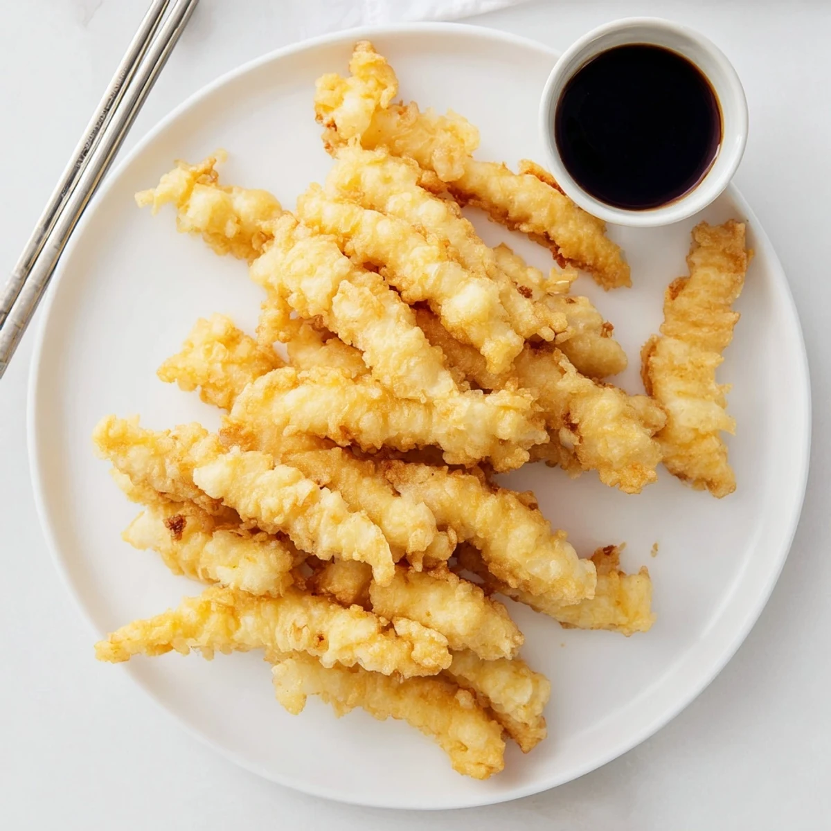 Japanese-style fried chicken strips with airy tempura coating drizzled with savory mirin vinegar sauce