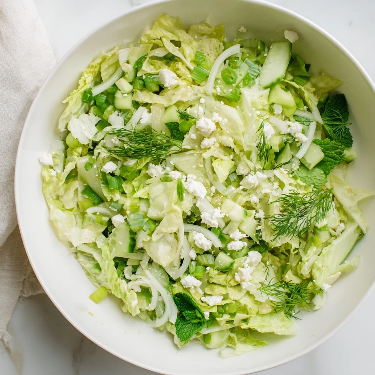 Fresh Maroulosalata Greek salad with crisp romaine lettuce, fragrant herbs, and tangy lemon-olive oil dressing