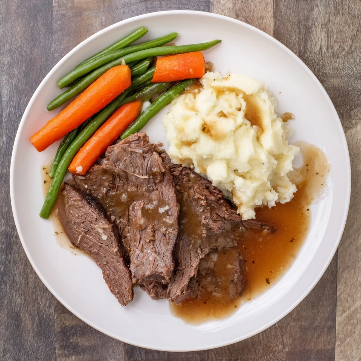 Golden brown Southern style pot roast plate with tender beef, rich gravy, and creamy mashed potatoes