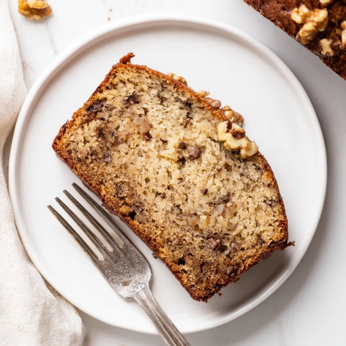 Gluten-free keto banana bread recipe with melted butter drizzled over a thick warm slice