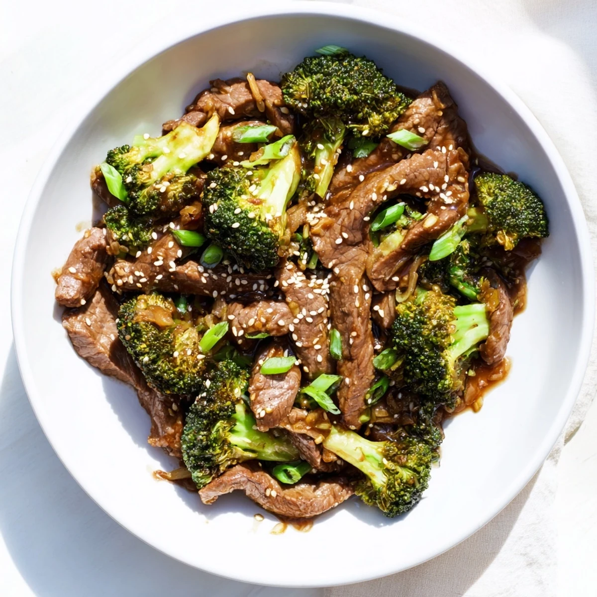Golden brown beef strips and bright green broccoli flolets coated in a rich glossy brown sauce