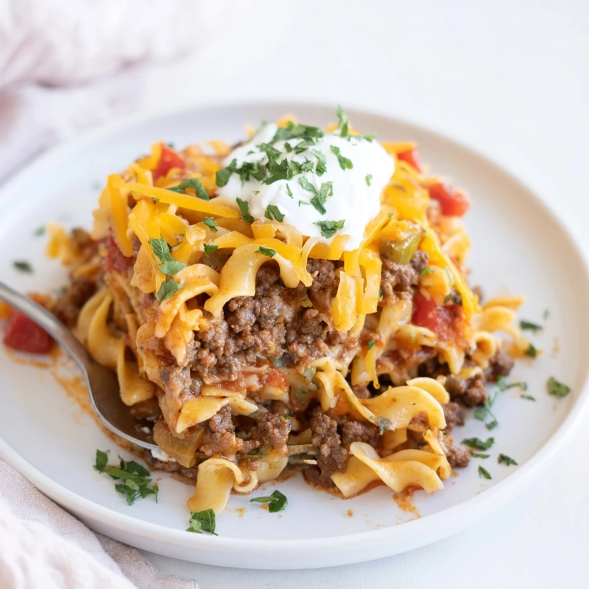 Beef Noodle Casserole bubbling with melted cheddar, golden edges, hearty family dinner