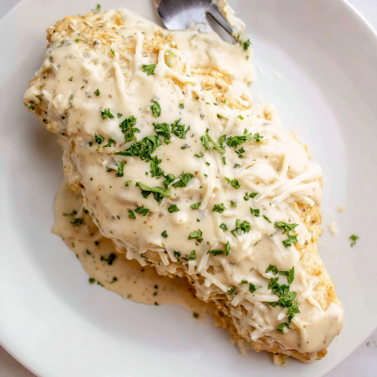 Oven-baked Caesar Chicken Recipe served hot with lemon squeeze and parsley