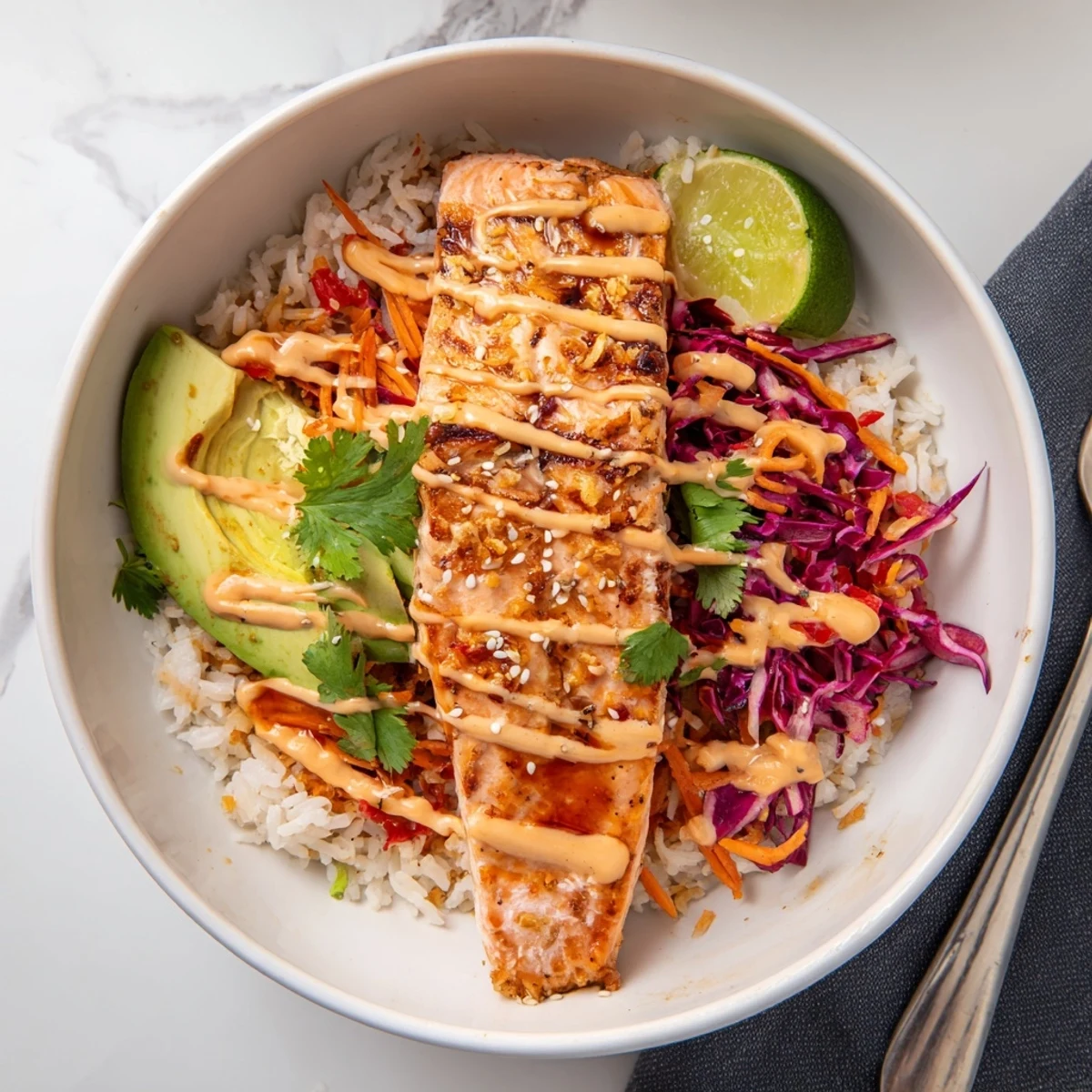 Weeknight Bang Bang Salmon Bowls Recipe plated warm, drizzled spicy creamy sauce