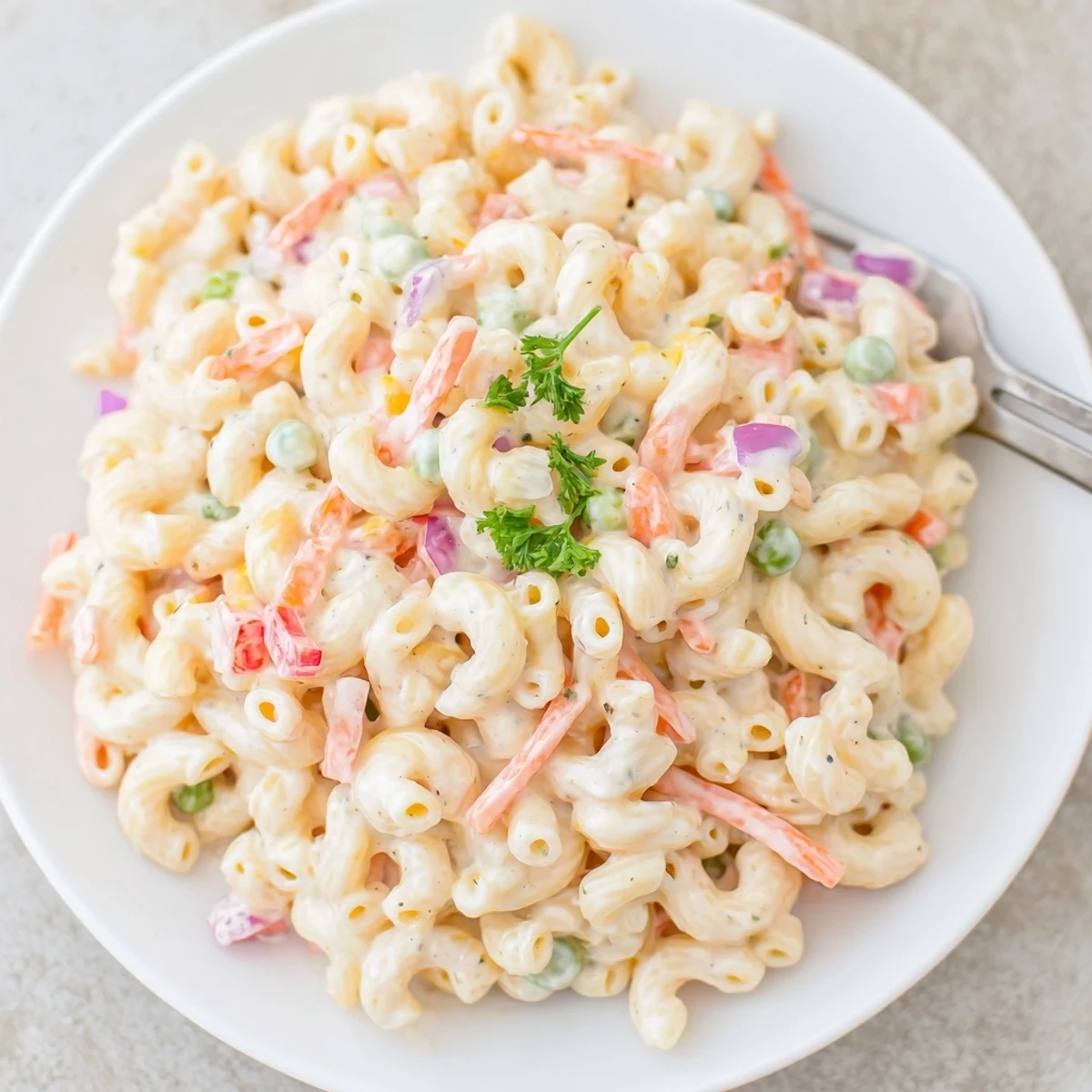 Creamy Macaroni Salad studded with crisp celery and peppers, chilled picnic side