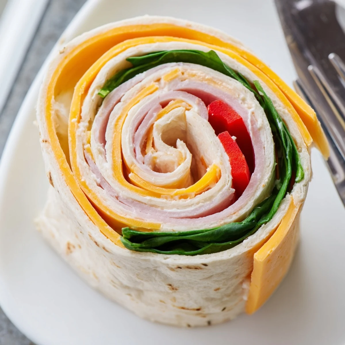 Homestyle Pinwheel Sandwiches showing creamy cheese, crisp veggies, served with toothpicks