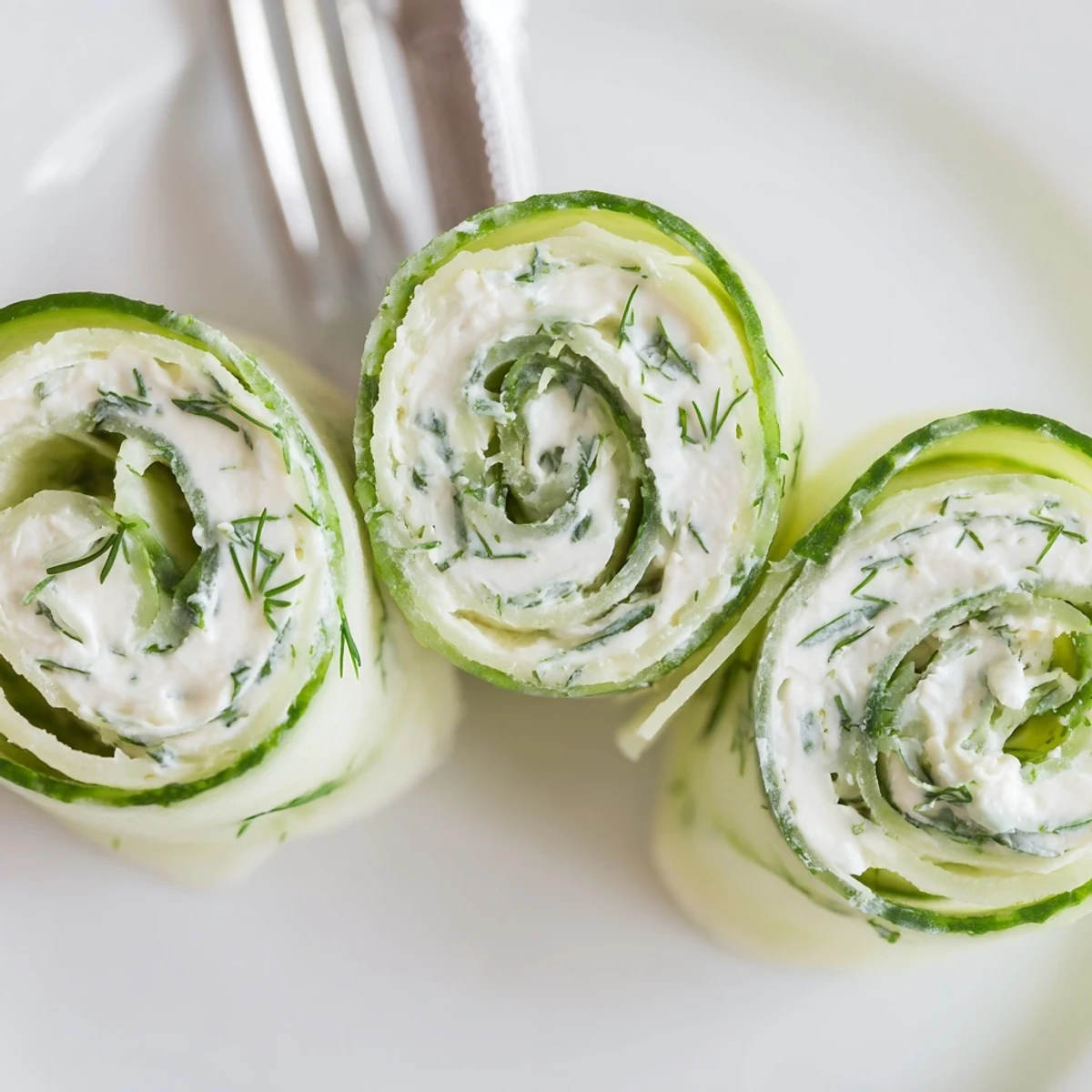 Chilled Cucumber And Dill Pinwheels arranged for parties with fresh dill garnish