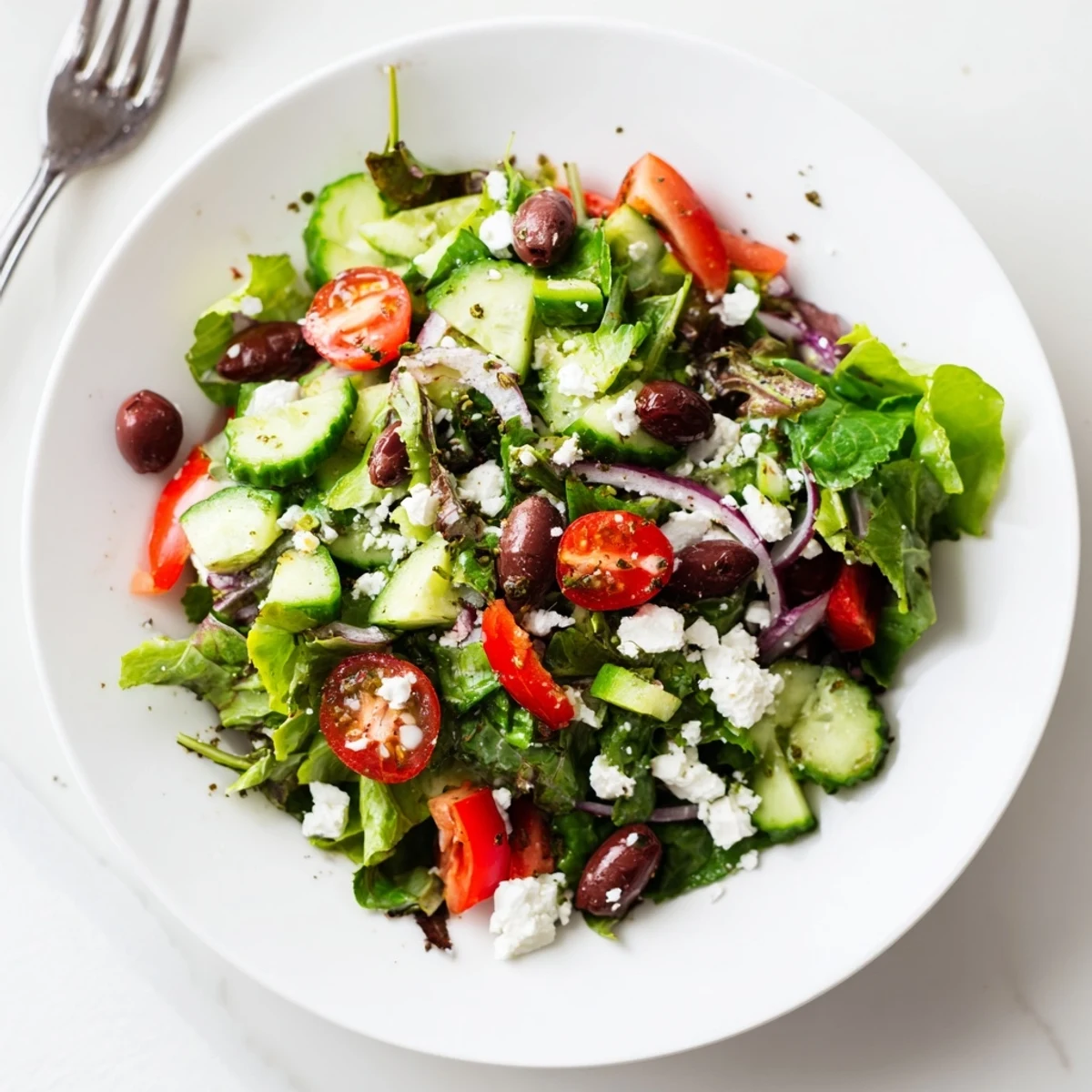 Bright summer bowl showing the Fresh Salad Recipe topped with tangy feta.