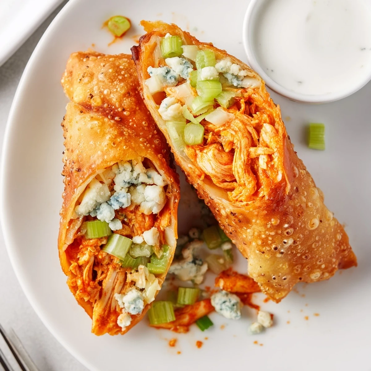 Buffalo Chicken Egg Rolls Recipe: golden, crispy rolls oozing spicy cheesy filling, served warm