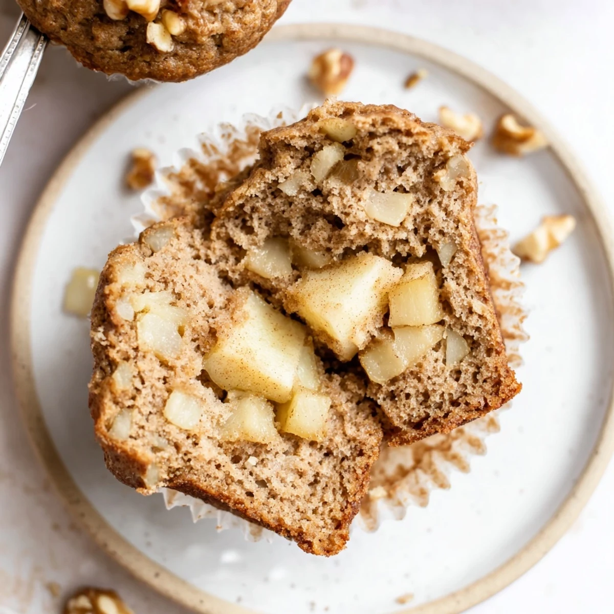 Fresh-baked Healthy Apple Cinnamon Greek Yogurt Muffins split open, revealing tender apples