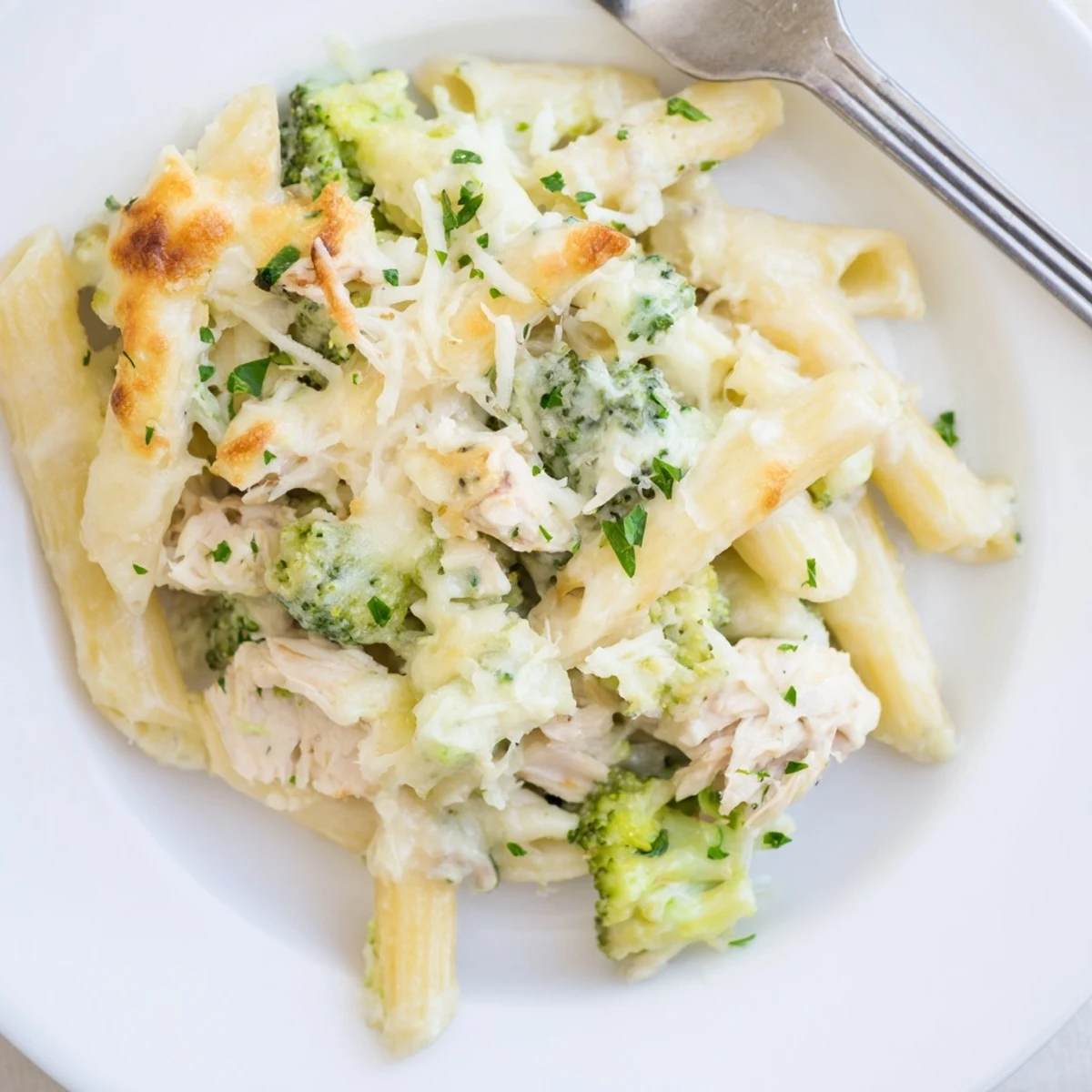 Cheesy Chicken Broccoli Alfredo Bake topped with golden mozzarella, ready to serve.