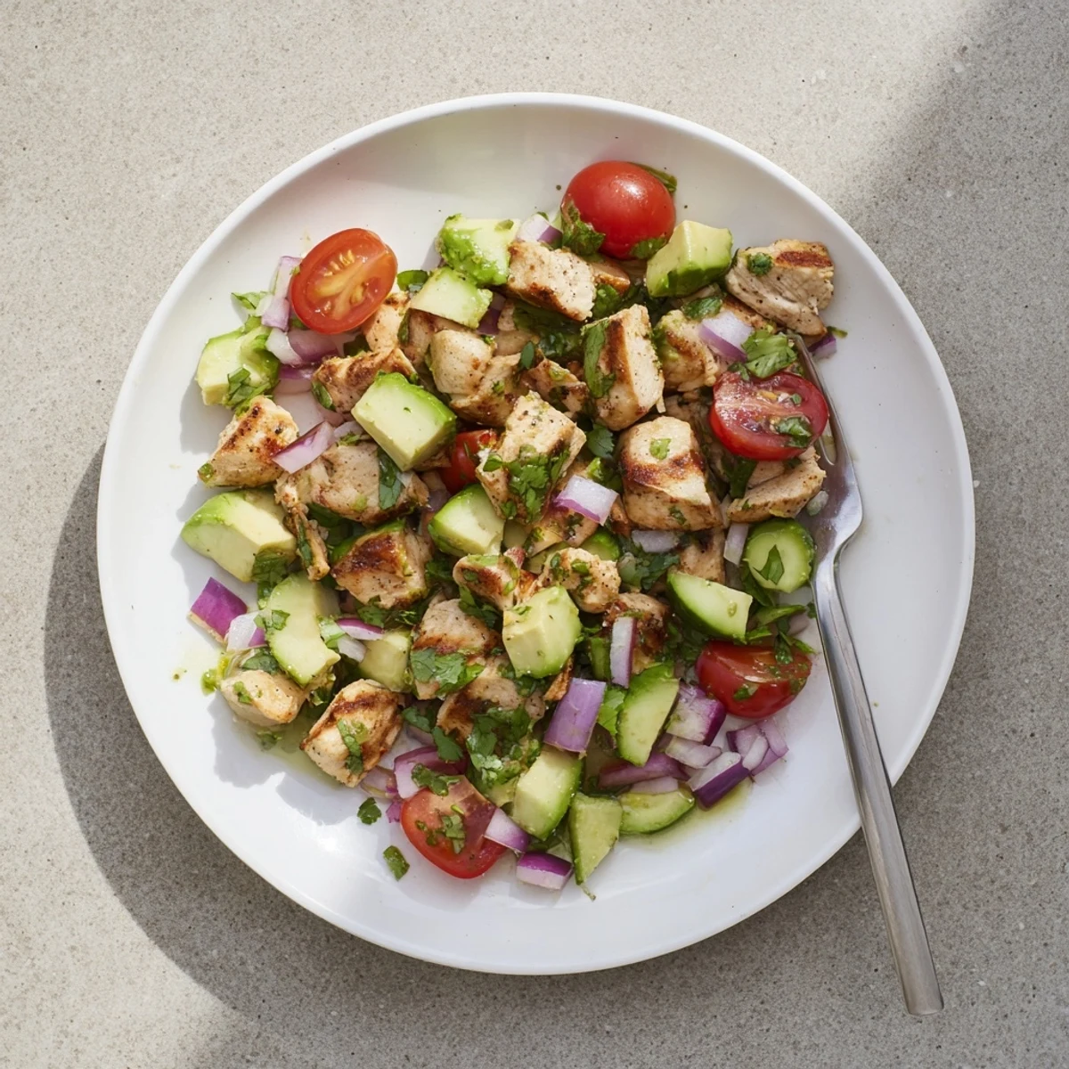Protein-packed healthy avocado chicken salad featuring diced chicken breast, creamy avocado, and vibrant garden vegetables