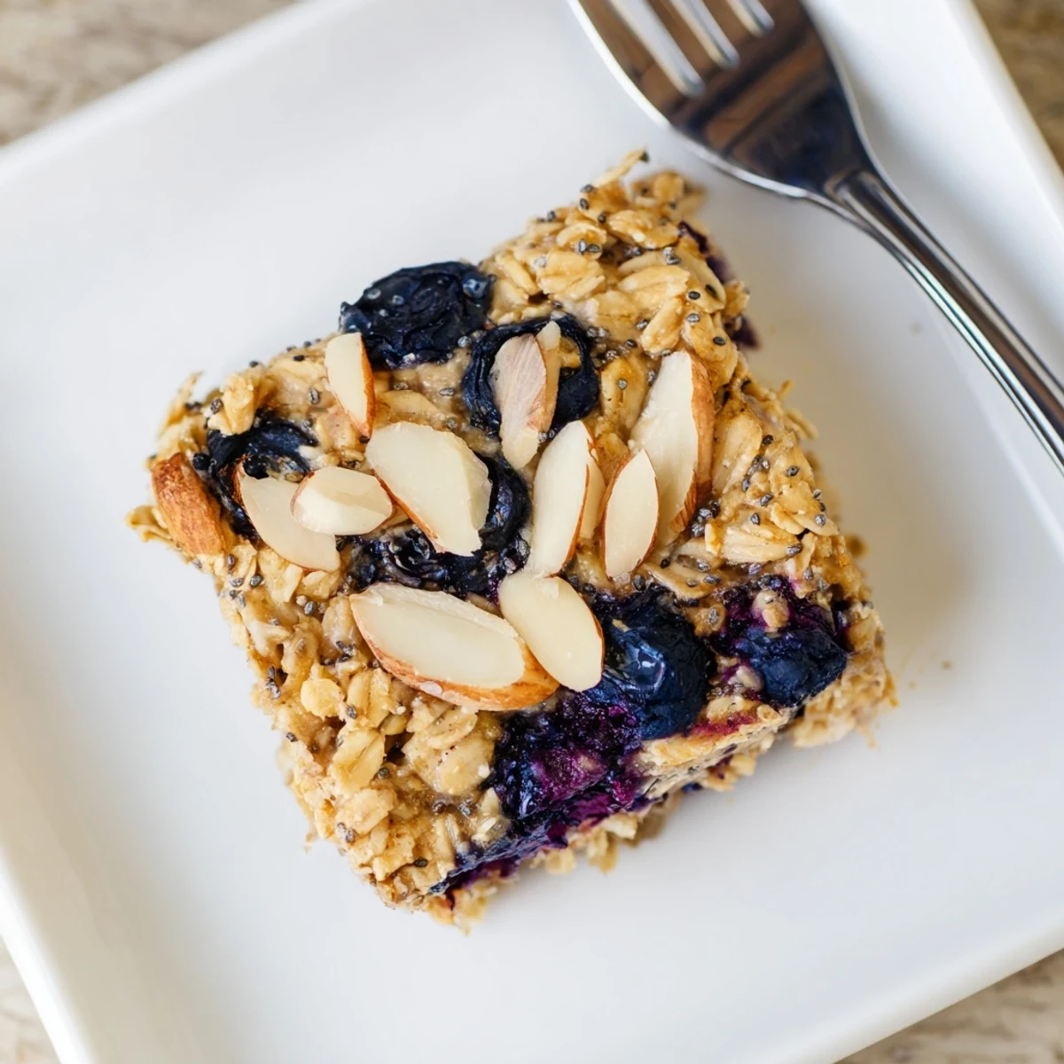 Golden high protein lemon blueberry breakfast bake topped with almonds and chia seeds