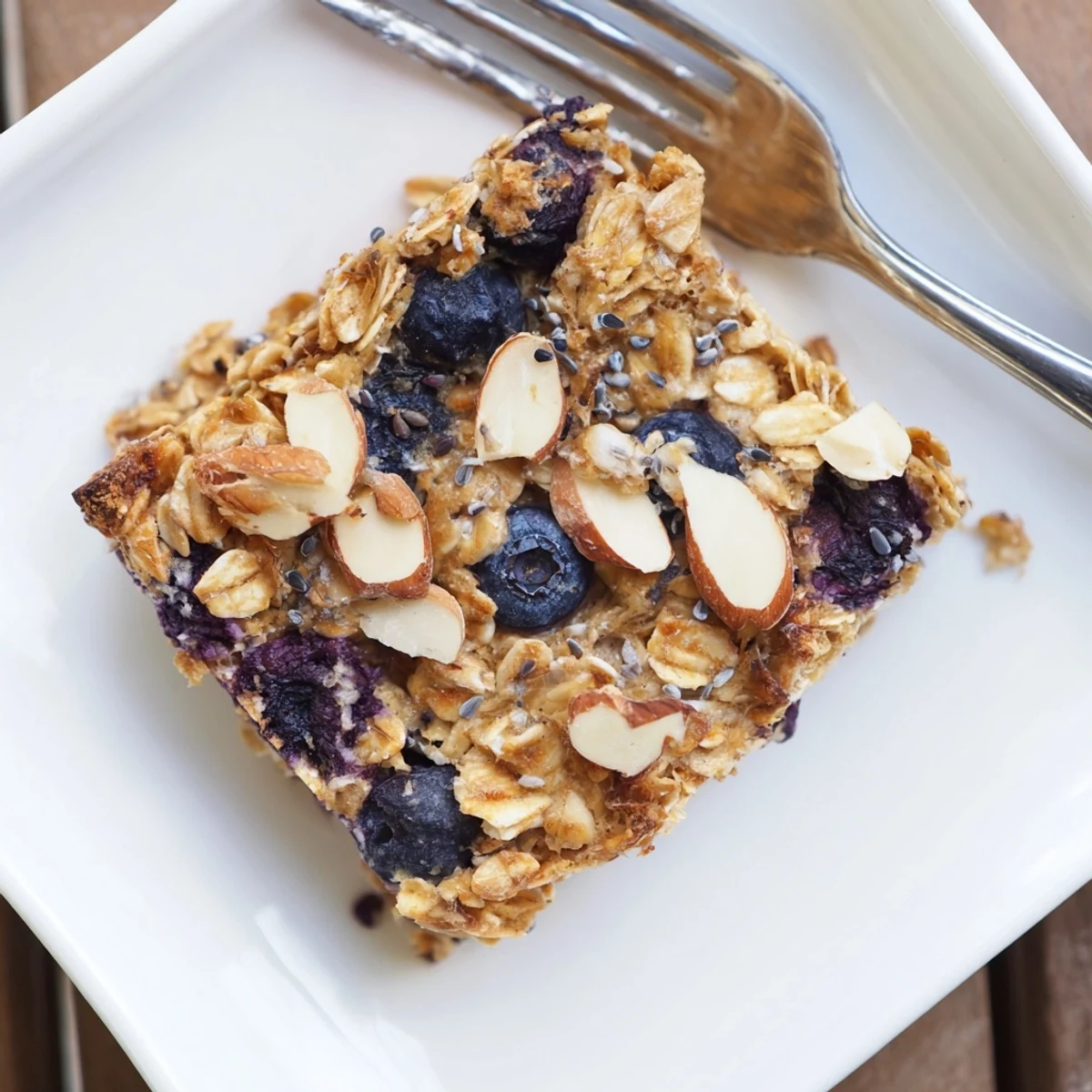 Slices of warm high protein lemon blueberry breakfast bake studded with juicy blueberries