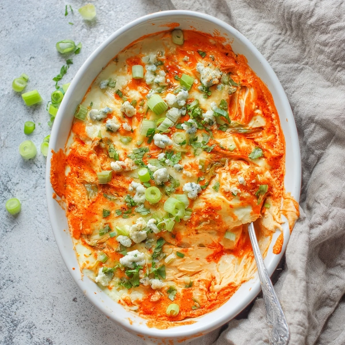 Creamy white beans and melted cheddar cheese blended with spicy buffalo sauce in a baking dish