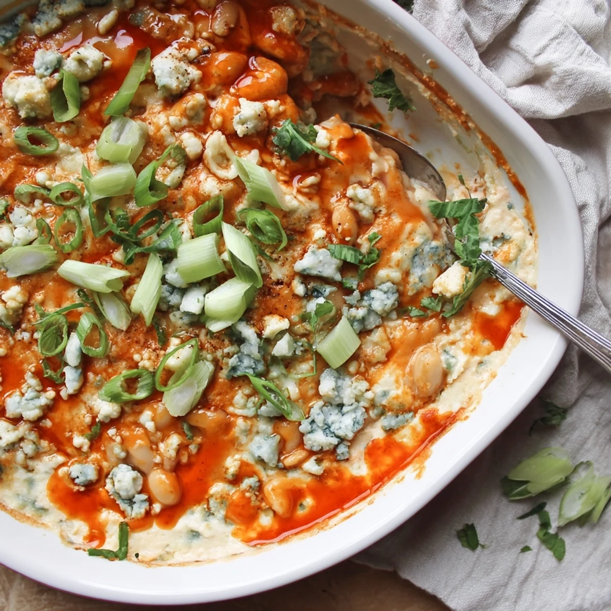Hearty white bean buffalo appetizer garnished with parsley and served warm for game day gatherings