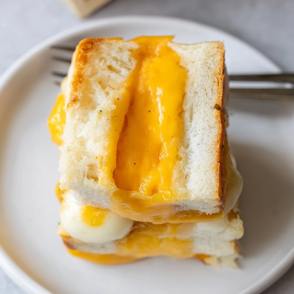 Tray of Mini Grilled Cheese Hawaiian Rolls brushed with garlic butter, golden