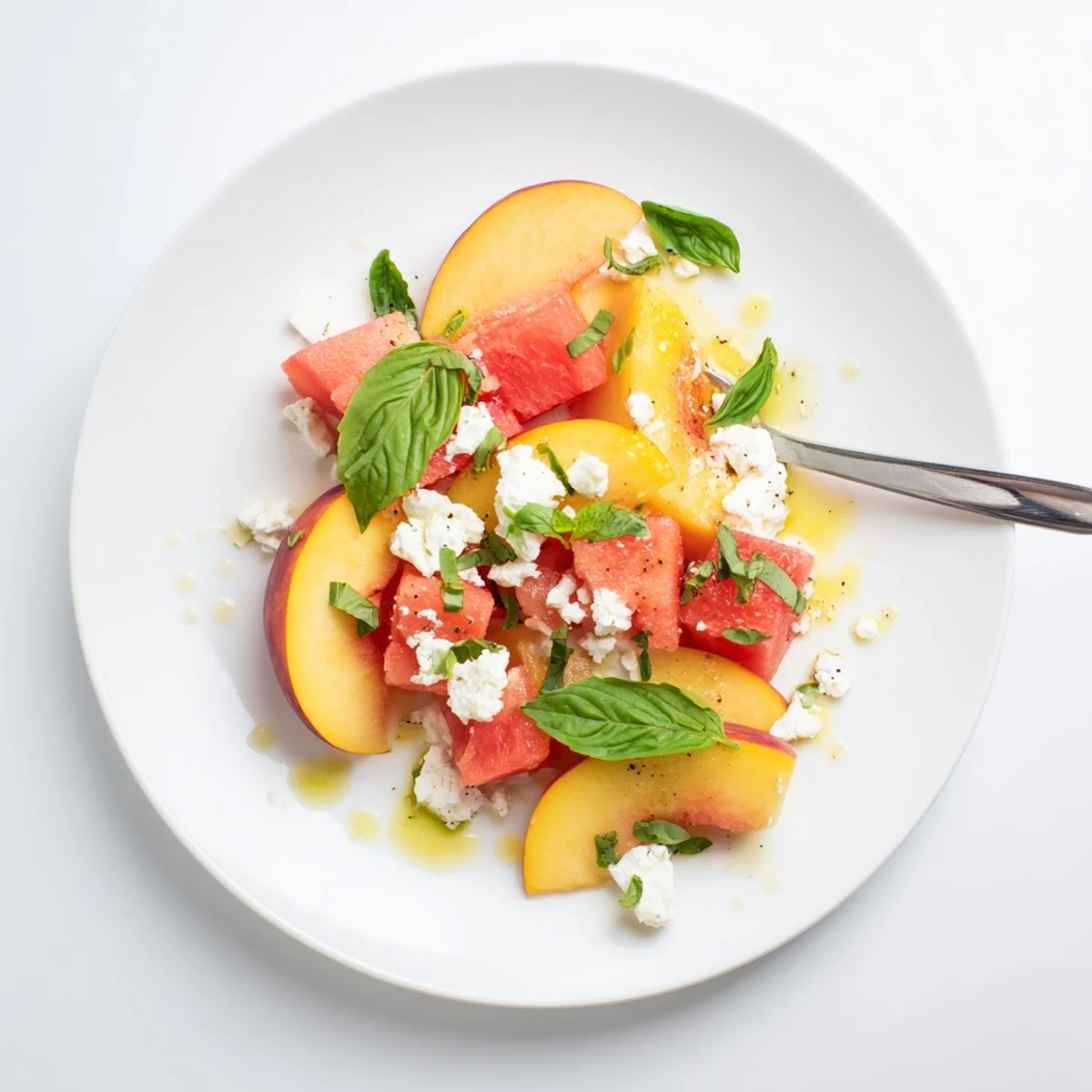 Bright Peach Watermelon Salad With Feta topped with chopped mint, lime-drizzled, chilled.