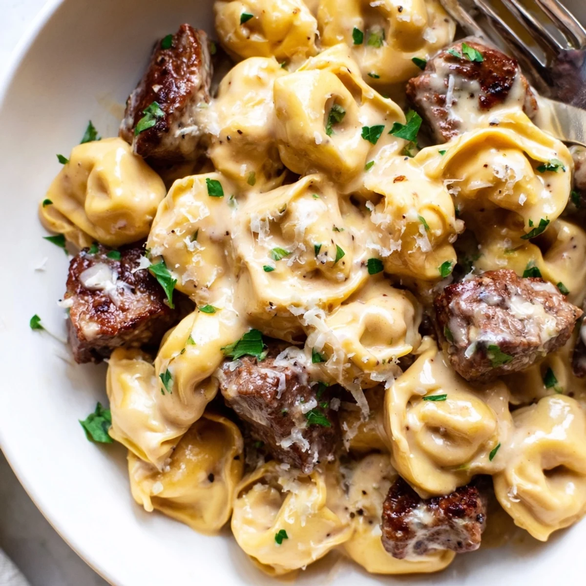 Garlic Steak Tortellini in creamy garlic sauce topped with fresh parsley garnish