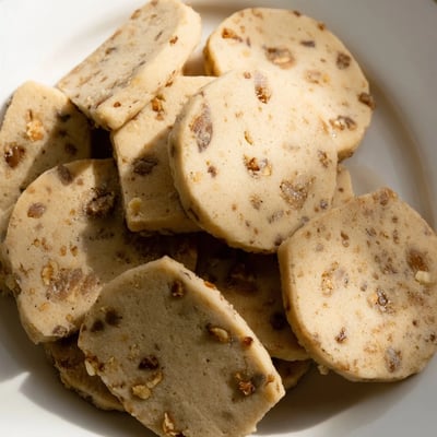 Espresso shortbread cookies studded with glistening toffee bits arranged on parchment paper