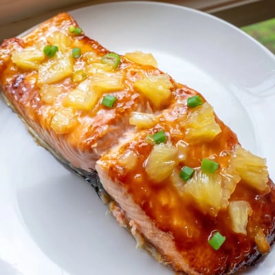 Honey pineapple glazed salmon recipe served over jasmine rice with fresh cilantro and lime wedges